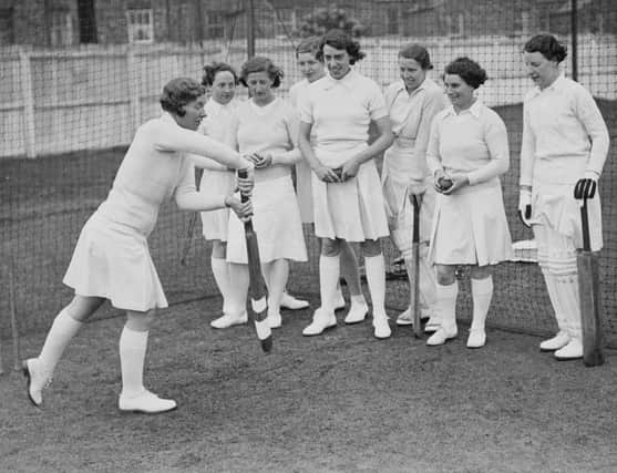 Cricketer Gwladys Joan Davis, team captain and left-arm medium-fast bowler for the Northampton Ladies Cricket Club team, instructs players in the forward defensive stroke during batting practice in the nets on 6th May 1938 at Northampton cricket ground.