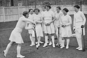 Cricketer Gwladys Joan Davis, team captain and left-arm medium-fast bowler for the Northampton Ladies Cricket Club team, instructs players in the forward defensive stroke during batting practice in the nets on 6th May 1938 at Northampton cricket ground.