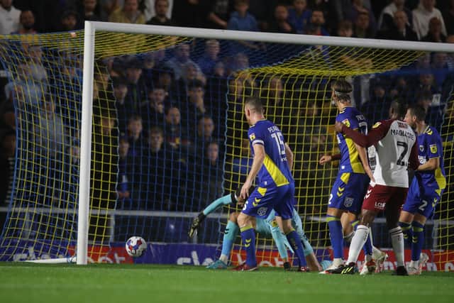 The ball rolls over the line for the Cobblers' first goal at AFC Wimbledon on Tuesday night