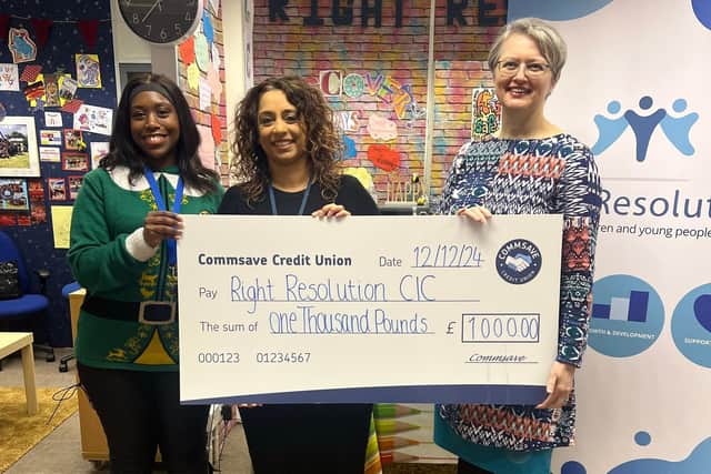 Georgia Naylor (left) from Commsave presenting a cheque