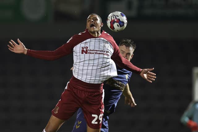 Cobblers striker Tete Yengi is challenged by AFC Wimbledon's Alex Pearce at Sixfields on Tuesday (Picture: Pete Norton/Getty Images)