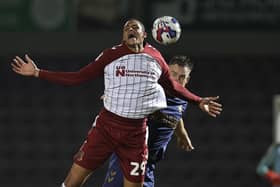 Cobblers striker Tete Yengi is challenged by AFC Wimbledon's Alex Pearce at Sixfields on Tuesday (Picture: Pete Norton/Getty Images)