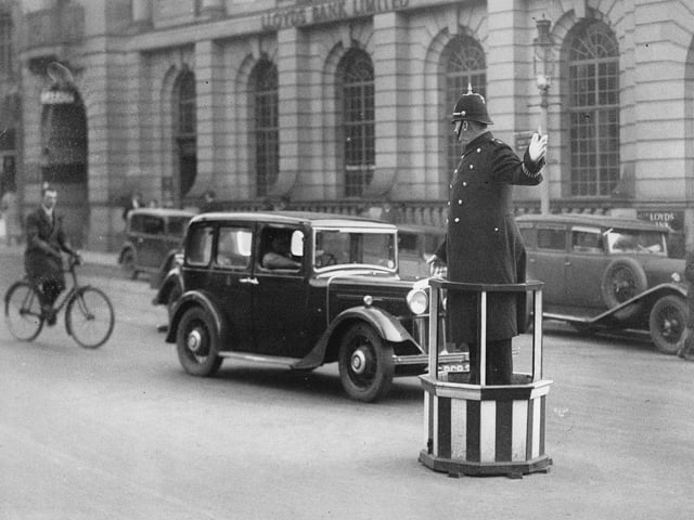 A policeman directs the traffic from a platform. Photograph. Northampton, England. Around 1930.  (Photo by Imagno/Getty Images)