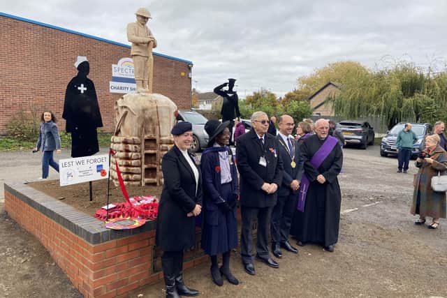 Vice Lord Lieutenant Morcea Walker MBE (pictured second from left) cut the ribbon to open the memorial with the sculptor, Peter Leadbeater.