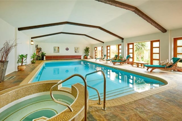 The home has traditional features as well as an indoor swimming pool, equestrian facilities and extensive parkland.