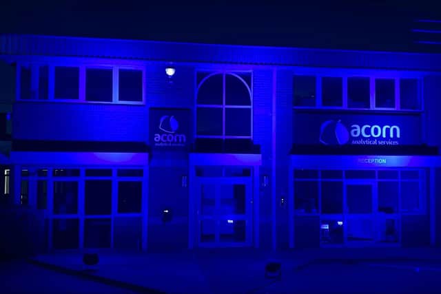 Acorn Analytical Services office on Moulton Park, Northampton lit up in blue.