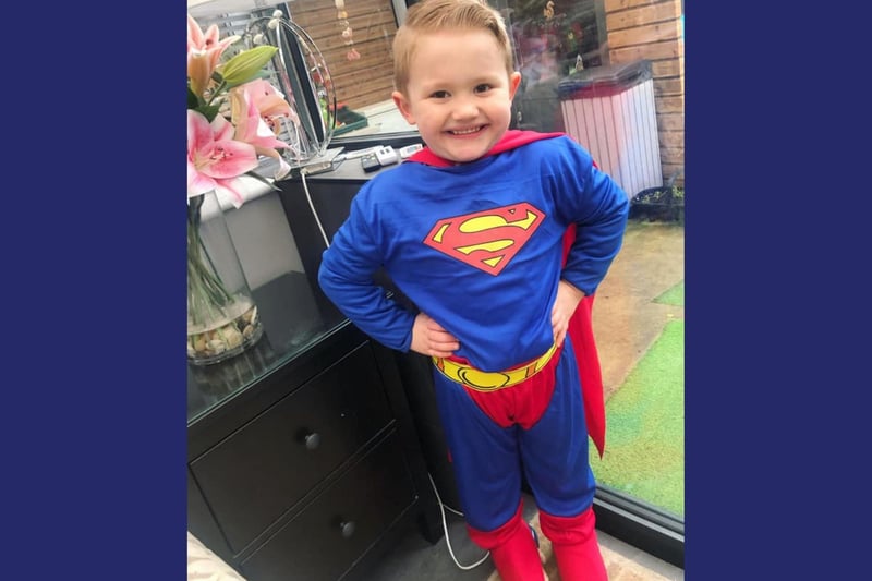 Four-year-old Charlie is ready to take on superhero day at Barnes Infant School.