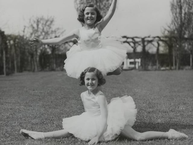 Eight Year Old Dancing Twins Win Championship, Little Nancy Munks, aged eight, who won the All-England Dancing Championship for 1934 out of 5,000 entrants, has a twin sister, Mollie, who won the championship last year at the age of seven. They live at Northampton. - The clever dancing twins - who are extremely alike - photographed at the Northampton home, Northampton. (Photo by Hulton Archive/Getty Images)