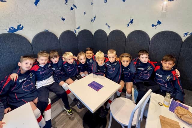 Kitted out and full of smiles – the Under-7s celebrate their link with TWENTY9 Café.