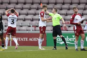 Referee Ross Joyce shows Aaron McGowan a red card.