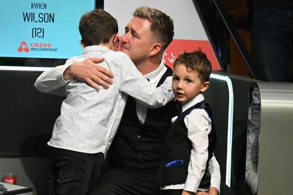 Kyren Wilson celebrates with sons Finley and Bailey at the Crucible