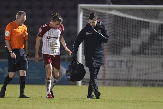 Ben Fox limps off against Wimbledon last Tuesday.