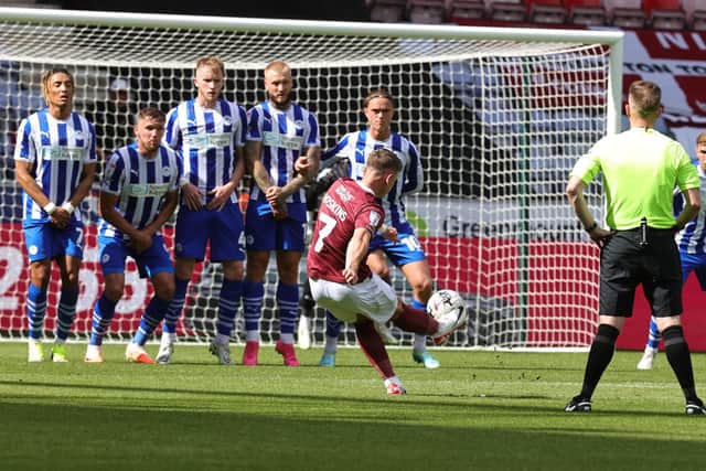 Sam Hoskins picks out the top corner with a fantastic free-kick in the first half of Saturday's League One game between Wigan and Northampton. Picture: Pete Norton.