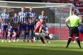 Sam Hoskins picks out the top corner with a fantastic free-kick in the first half of Saturday's League One game between Wigan and Northampton. Picture: Pete Norton.