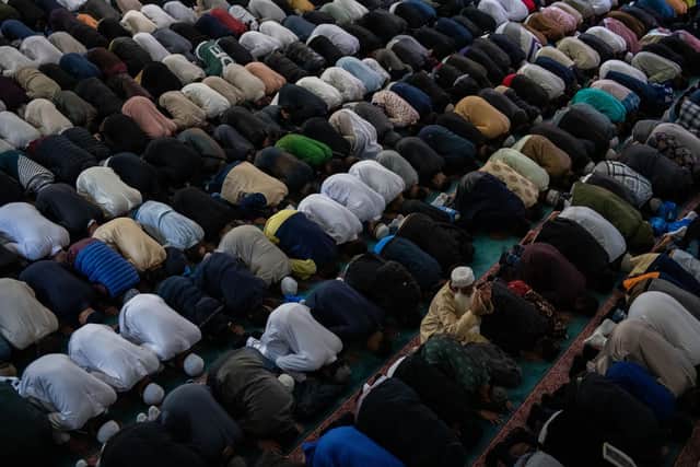 Library picture. Men take part in morning prayers during Eid Al-Fitr celebrations (Photo by Chris J Ratcliffe/Getty Images)