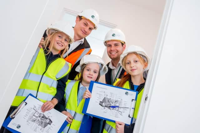 Students from Abbey C of E Academy with Sam Fisher, Assistant Sales Manager from Orbit Homes and Adam Daly, Deputy Principal at Abbey C of E Academy. 