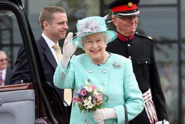The Queen waving goodbye to the crowds waiting outside the Corby Cube in 2012