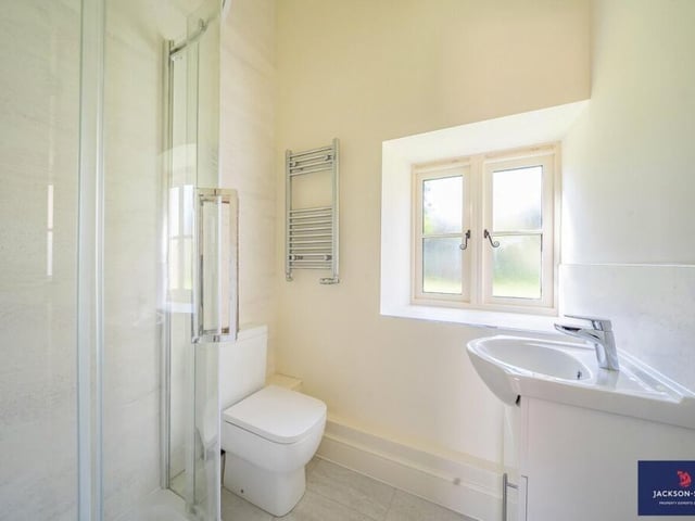 A family bathroom with a walk-in shower and heated towel rail