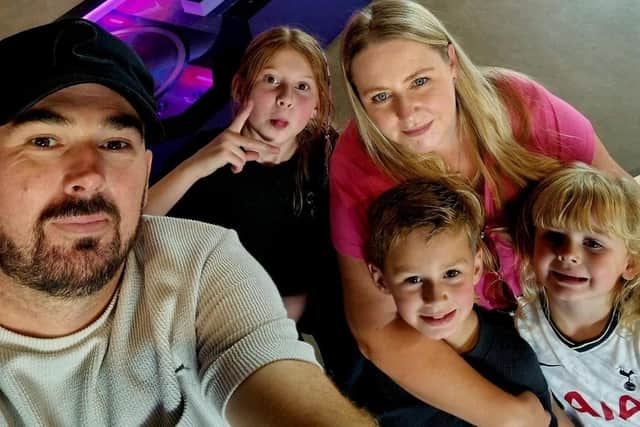 Alex Buey, left, with his wife Amy and the couple's three children