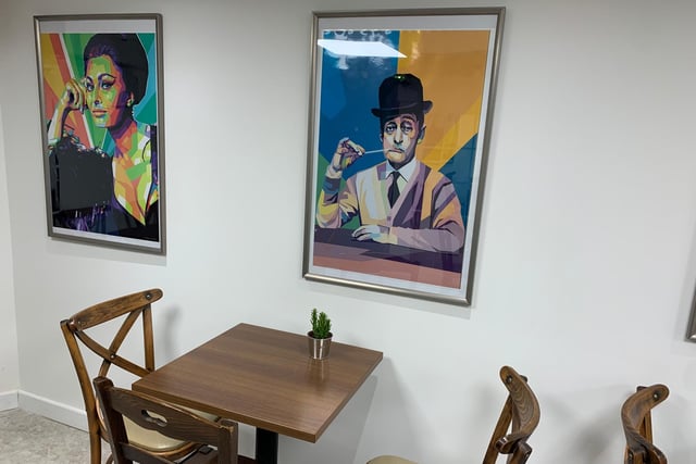 Bright and colourful paintings of famous faces line the walls