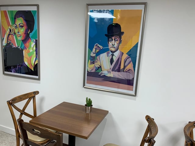 Bright and colourful paintings of famous faces line the walls