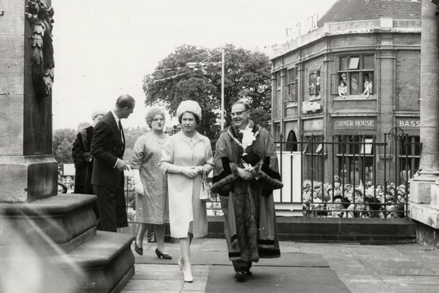 The Queen passing the cenotaph in Kettering alongside Kettering mayor Ernest Crayford on the way to the art gallery during visit on July 9, 1965