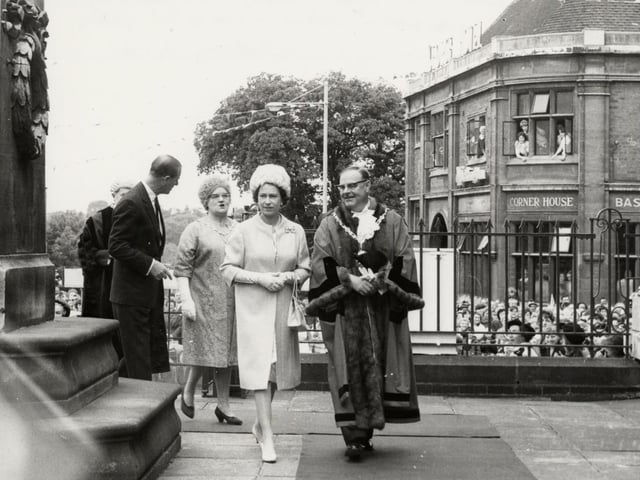 The Queen passing the cenotaph in Kettering alongside Kettering mayor Ernest Crayford on the way to the art gallery during visit on July 9, 1965