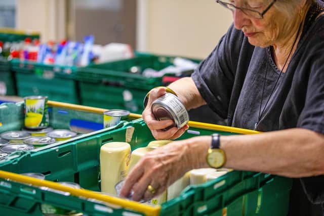Volunteer packs emergency food parcels