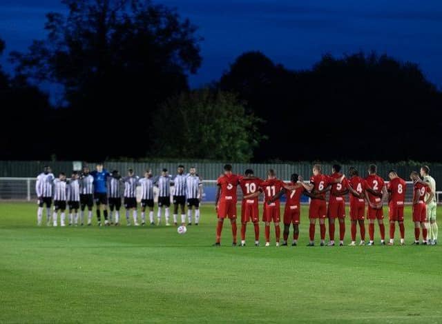 The Brackley and Hereford players paid their respects to Queen Elizabeth II ahead of kick-off at St James Park on Tuesday