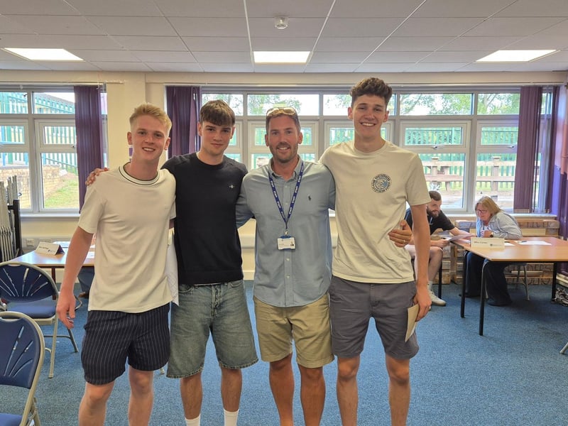 Josh, Harry, and Arthur celebrate their excellent results with Mr Mills.