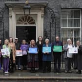 Green Party MP Hannah Spencer (third left) and actor Anna Maxwell Martin (fifth left) with parents and campaigners from No School Fines delivering a petition to number 10 Downing Street, London, calling on the government to stop fining parents for their child's non-attendance at school. Picture: Stefan Rousseau/Press Association