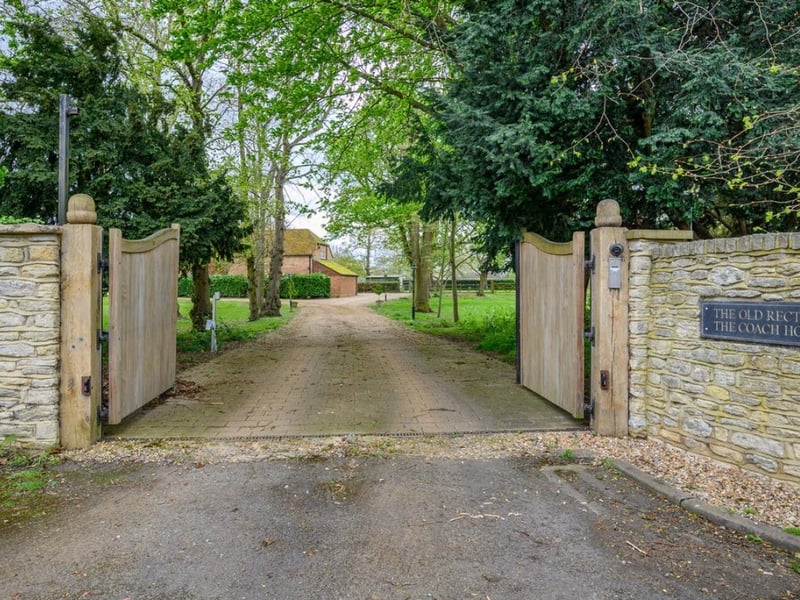 These gates lead you into this large property set across nearly four acres of land