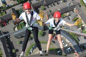 Abseilers Sinead Birks and Danielle Yates go 'over the edge' of the lift tower.