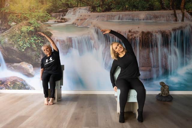 Kristina and friend from Soo Yoga demonstrating a chair yoga position.