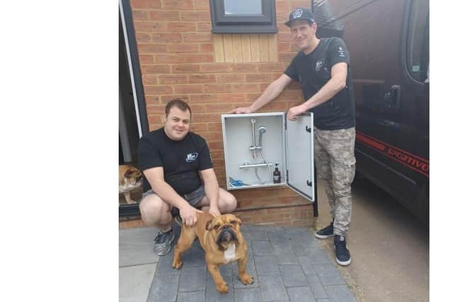 Owners of Pexel Home Improvements, Daryl Miles (left) with Theo Bennie (right) with the 'doggy wash box'.