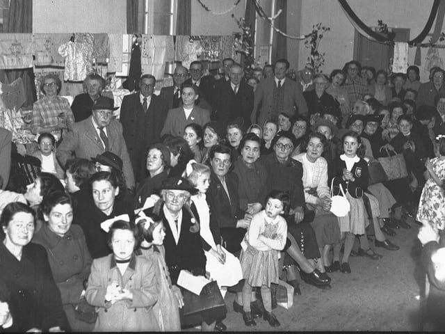 Children and old people at celebration in hall