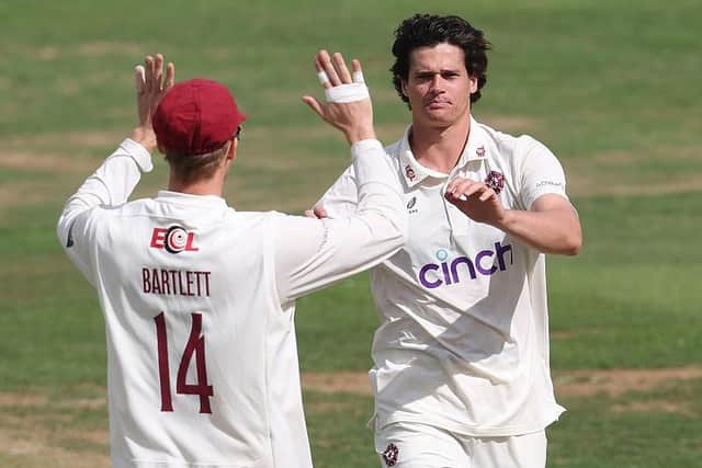 Liam Guthrie celebrates with George Bartlett after taking the wicket of Ben Compton (Photo by David Rogers/Getty Images)