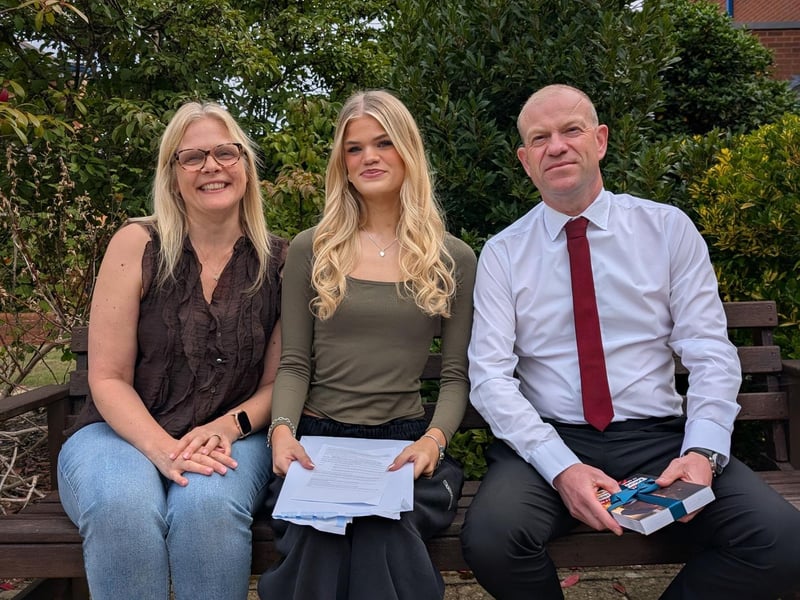 Holly, a student at Northampton High School, with her proud parents on GCSE results day