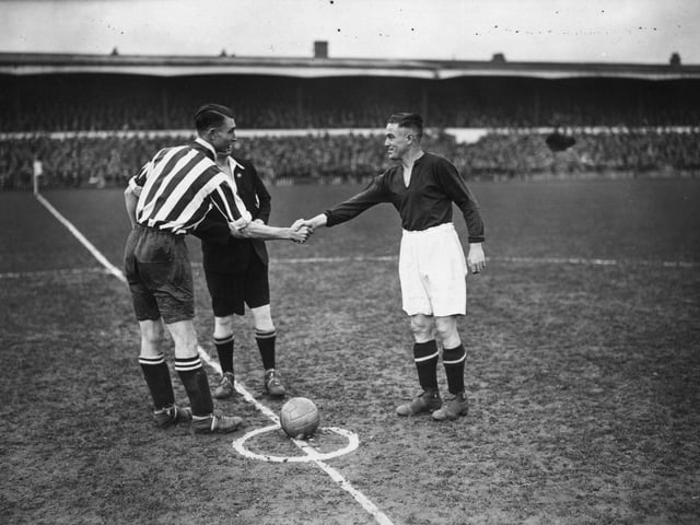 18th January 1934: Southampton captain, Bradford, shakes hands with Northampton captain, Crilly, before the kick off of an FA Cup tie replay between Northampton Town and Southampton at Northampton. (Photo by J. A. Hampton/Topical Press Agency/Getty Images)