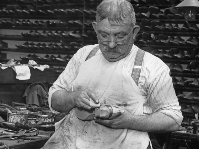 16th October 1936: A man works on a pair of shoes with scooped-out heels for actress Marlene Dietrich, at a Northampton factory. (Photo by Fred Morley/Fox Photos/Getty Images)