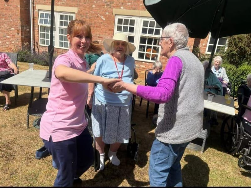 Sarah, Activities Coordinator dances with the residents at Brampton View Care Home