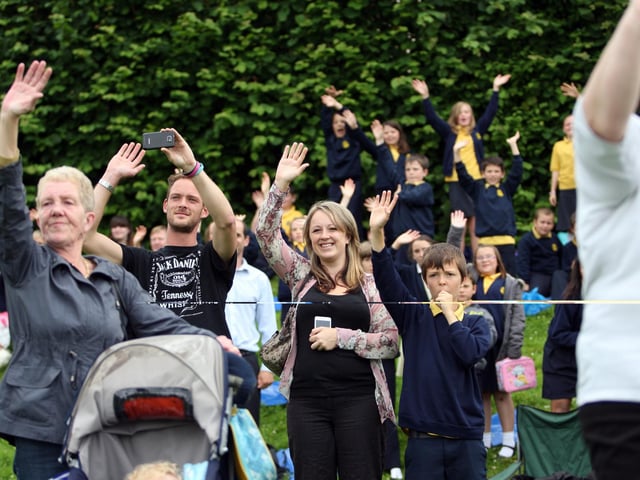 Crowds waving goodbye to Bob at his retirement party