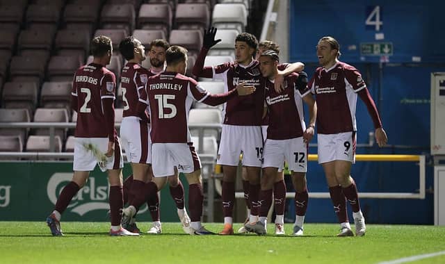 Cobblers are all smiles after Nesta Guinness-Walker's opener. Picture: Pete Norton