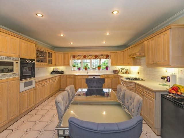 A large farmhouse kitchen comes with multiple bench space and room for a breakfast table
