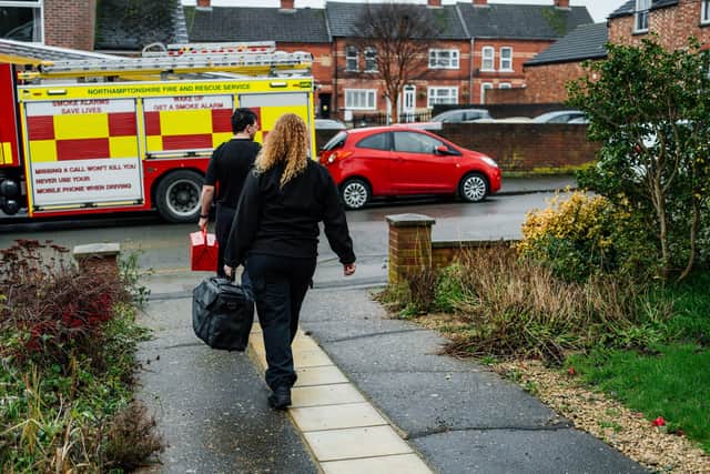 Two firefighters leaving a home fire safety visit