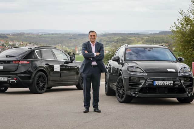 Michael Steiner, Porsche's head of research and development boss, with the prototype Macan EVs