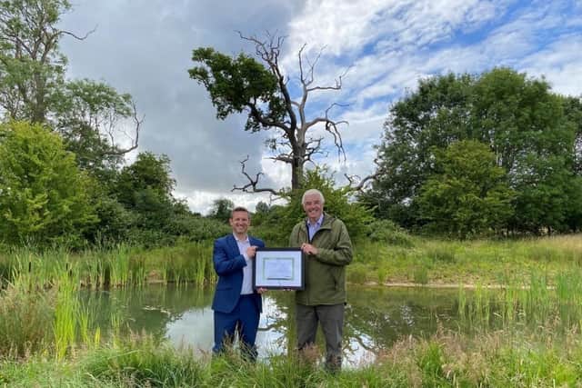 Robert James, Project Director for Bellway, receiving the Gold Supporter Award from Dr Tom Tew, CEO of NatureSpace Partnership, at a compensation site in Oxfordshire