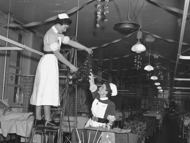 Nurses putting Christmas decorations up in children's ward, NGH, December 23, 1958