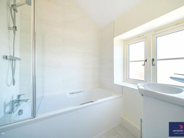 A second bathroom in the property has a bathtub and shower