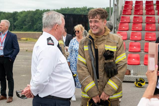 Chief Fire Officer Mark Jones (left) speaks to one of the new apprentices